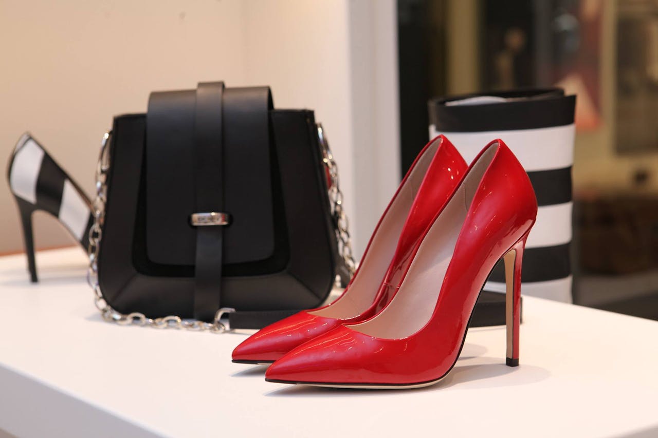 services-01 Showcasing sleek red stilettos and a chic black handbag in a luxury boutique setting.